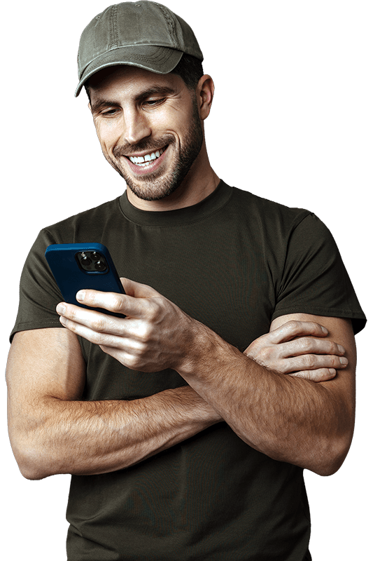 US veteran looking at his phone smiling
